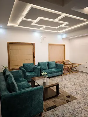 a living room with blue couches and a table at Girassol Serviced Villa in Vythiri
