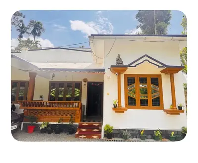 a small white house with a porch at NirvanaStays-Blooms in Tariyod