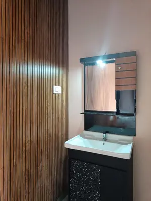 a bathroom with a sink and a mirror at Eden Spot in Marayoor