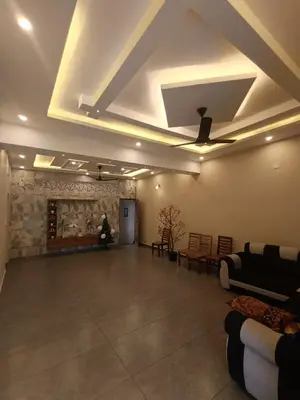 a living room with a couch and a ceiling at Eden Spot in Marayoor