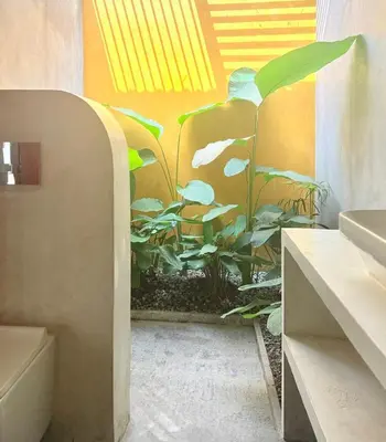 a bathroom with a plant mural on the wall at Chandra - Journey back to you in Honganūr