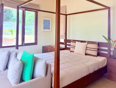 a bedroom with a canopy bed and a couch at Chandra - Journey back to you in Honganūr