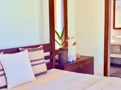 a bedroom with a bed with a plant on a table at Chandra - Journey back to you in Honganūr