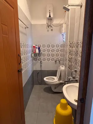 a bathroom with a toilet and a sink at Krish homes in Coimbatore