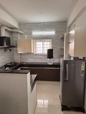 a kitchen with a stainless steel refrigerator and a window at Krish homes in Coimbatore