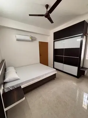 a bedroom with a bed and a ceiling fan at Krish homes in Coimbatore