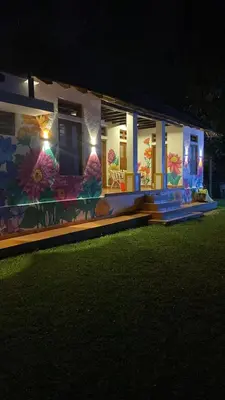 a house with a painting on the side of it at Some where Else Musiris Heritage in Parūr