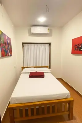 a bedroom with a large bed in a room at Some where Else Musiris Heritage in Parūr