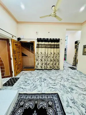 a living room with a marble floor and a ceiling fan at Flats in CITY Centre Next to Nexus Mall, 1km from bus stand in Mysore