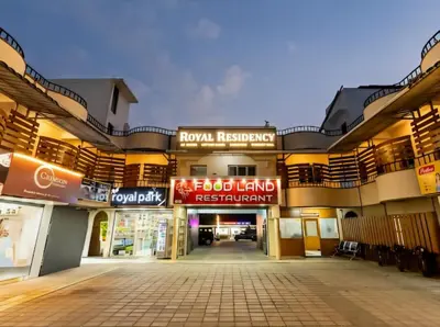 an empty shopping mall with signs in front of it at Royal Residency in Coimbatore