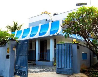 a blue and white house with a blue gate at BGF Residency - Cottage in Coimbatore