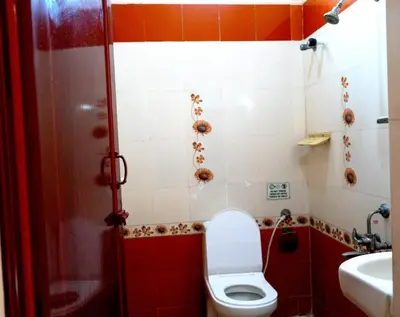 a bathroom with a toilet and a sink at BGF Residency - Cottage in Coimbatore