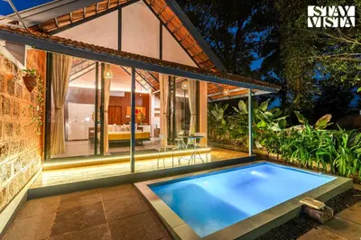 an indoor pool in the backyard of a house at StayVista at The Sattva Grove with Pool, Views in Wayanad
