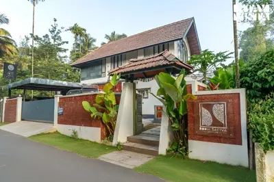 a house with a sign in front of it at StayVista at The Sattva Grove with Pool, Views in Wayanad