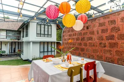 a dining room with a table and some lanterns at StayVista at The Sattva Grove with Pool, Views in Wayanad