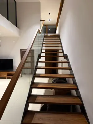 a staircase with wooden steps in a house at Ozone The Misty Villa ooty ,Three Bed Room Luxury Private Jacuzzi Villa in Ketti