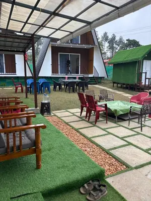 a patio with chairs and tables and a table with grass at Bethel resorts in Kanthalloor