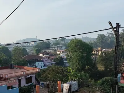 a view of a city with houses and trees at RajPari Stay in Madikeri