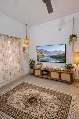a living room with a large flat screen tv at Nele Mane in Mysore