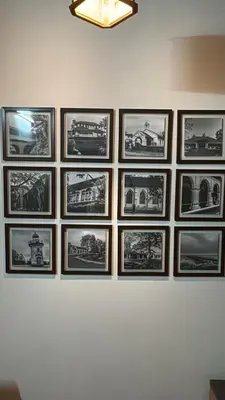 a group of pictures hanging on a wall at Souparnika Heritage in Tellicherry