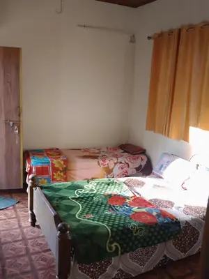 a bedroom with two beds in a room at Dreams home estate stay coorg in Suntikoppa