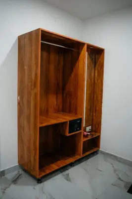 a wooden cabinet with a radio inside of it at Fenna Resort And Spa, coorg in Kushālnagar