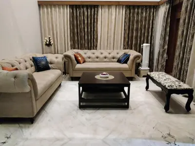 a living room with two couches and a coffee table at Kalariyullathil Homestay
