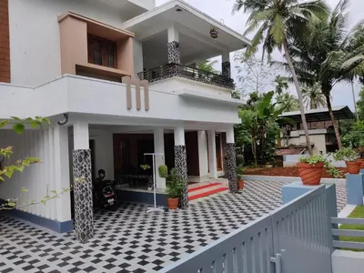 a house with a black and white checkered floor at Kalariyullathil Homestay