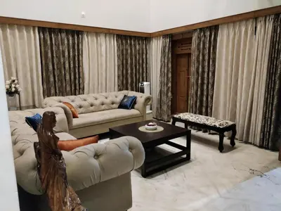 a living room with a couch and a table at Kalariyullathil Homestay