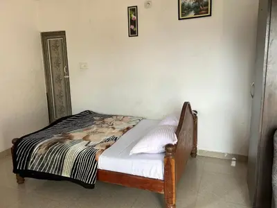 a small bed in a room with at D&D Residency in Mysore