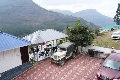 a truck parked in a parking lot next to a house at Joys Santa in Vattavada