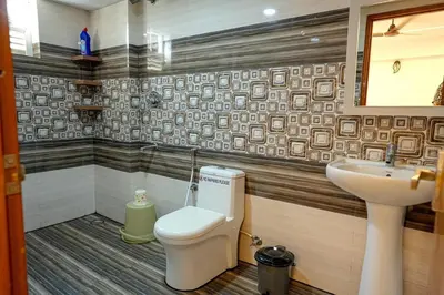a bathroom with a toilet and a sink at 1 Bhk Luxury Flat in Samudhra Apartments -208 in Guruvāyūr