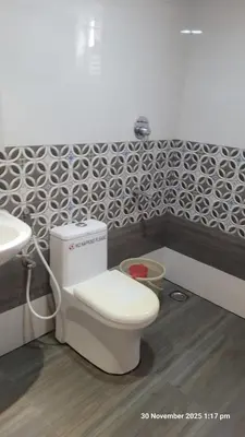 a bathroom with a toilet and a sink at 1 BHK Luxury Flat in Samudhra Apartments-105 in Guruvāyūr