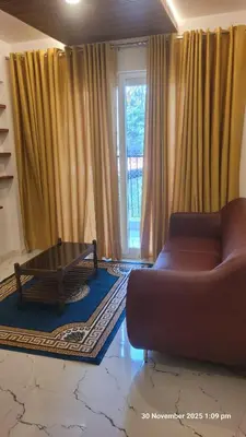 a living room with a couch and a coffee table at 1 BHK Luxury Flat in Samudhra Apartments-105 in Guruvāyūr
