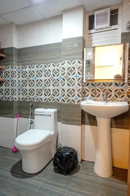 a bathroom with a toilet and a sink at Luxury room in Guruvayur Samudhra Apartments in Guruvāyūr
