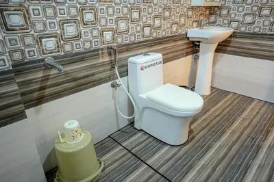 a bathroom with a toilet and a sink at Luxury room in Guruvayur Samudhra Apartments in Guruvāyūr