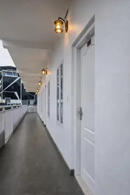 an empty hallway with a door on the side of a building at White Oasis Residence Vythiri 3 star in Padinjarathara