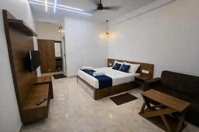 a hotel room with a bed and a couch at White Oasis Residence Vythiri 3 star in Padinjarathara