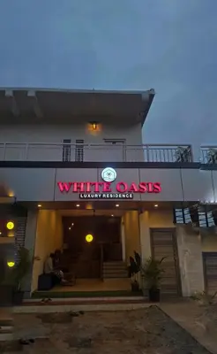 a building with a sign that reads white dacus inventoryled at White Oasis Residence Vythiri 3 star in Padinjarathara