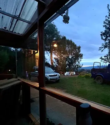 a window view of a car parked in a yard at Atwood Chalet in Coonoor