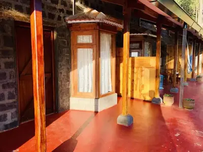 a room with a wooden door and a floor at Atwood Chalet in Coonoor