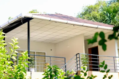 a house with a porch and a balcony at Kghomestay in Pallipuram