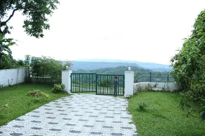 a gate in a yard with a grass field at Skyfall Villa in Chillithodu