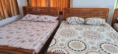 two twin beds sitting next to each other in a bedroom at Stay41 in Vālpārai