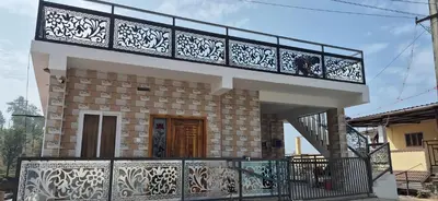 a small house with a balcony and a porch at Stay41 in Vālpārai