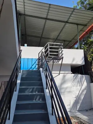 a set of stairs leading up to a building at Pearl Farmstay in Kushālnagar