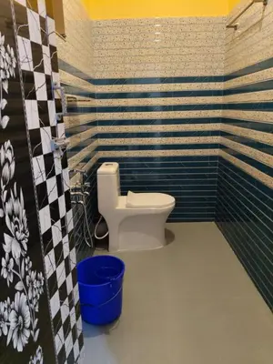 a bathroom with a white toilet in a room at Brigmonsiya in Vattavada