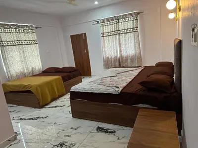 a bedroom with two beds in a room at The Royal Palace & KGN Rooms & Restaurants in Belagula