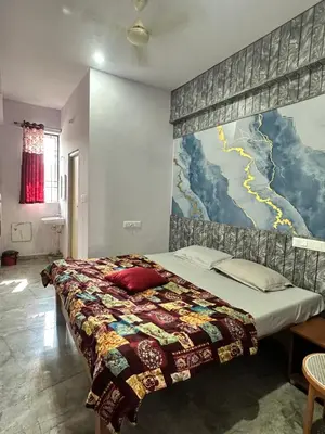 a bedroom with a bed with a large mural on the wall at The Royal Palace & KGN Rooms & Restaurants in Belagula