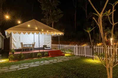 a gazebo in a yard at night at Coorg Kavery Estate by Aarika Resorts in Napoklu